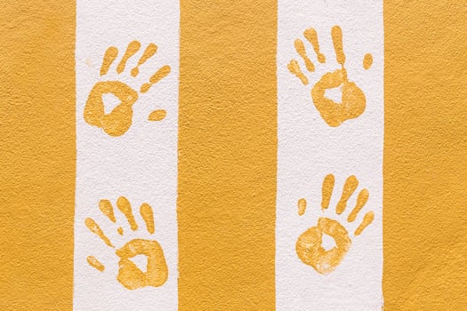 Hand print on orange and white wall photo