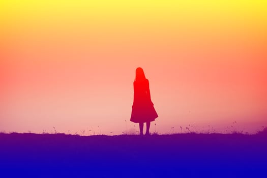 silhouette of a young woman standing alone photo