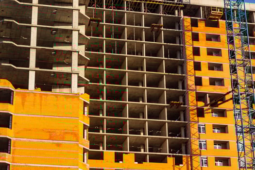 Concrete building in progress with cranes photo