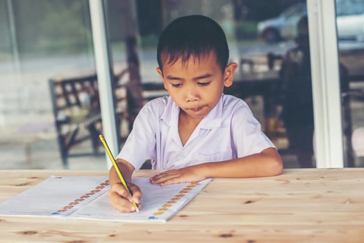 Cute little boy doing his homework photo