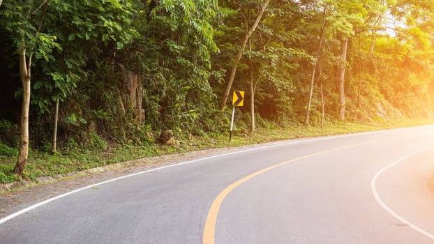 Sun in horizon over asphalt road photo