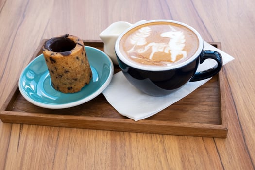 Hot latte with cookies on a wooden table photo