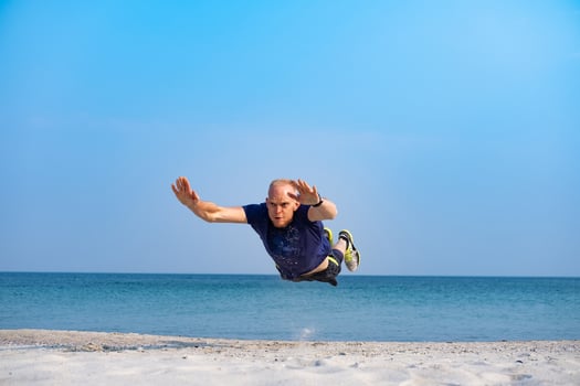 Young male athlete training in sunny day on the beach photo