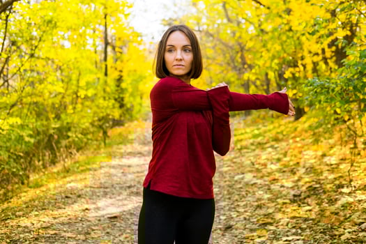 Young happy woman runner training in sunny autumn park photo