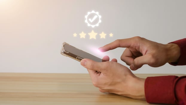 Close up on Customer Man Hand press on smartphone screen with gold five star comment icon and excellent press level for best rating in business idea service review. photo