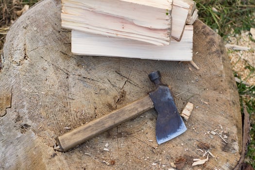 Close up piture of chopping firewood, country photo with wood and axe