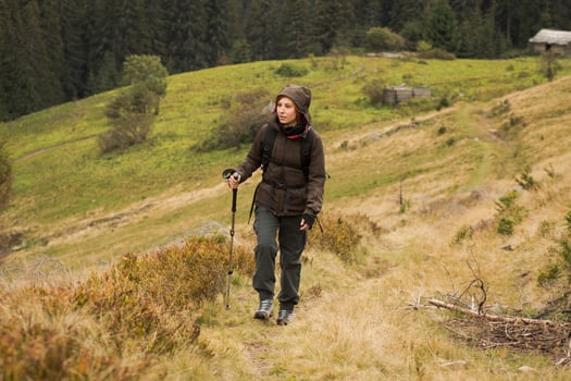 young woman hiker in autumn forest photo