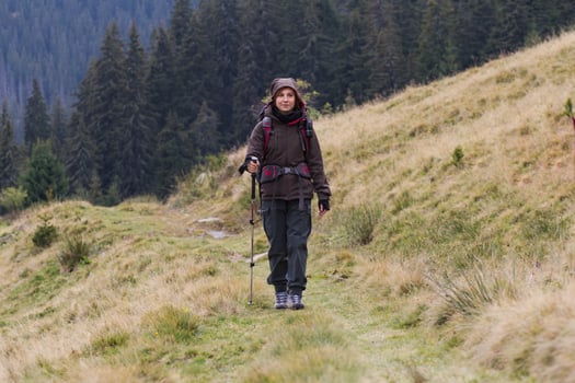 young woman hiker in autumn forest photo