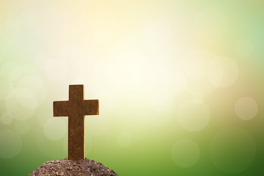 cross on tomb nature blur background photo