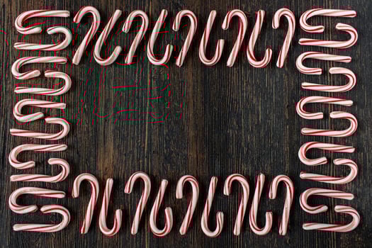 alternating direction candy cane border with copy space on rustic wood table flat lay photo