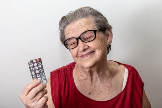 Elderly woman sad about running out of medicine photo