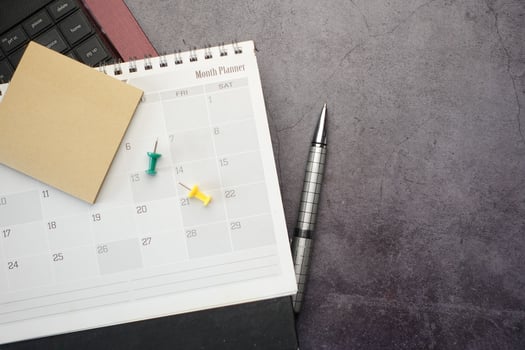 flat composition of calendar and laptop on black background photo