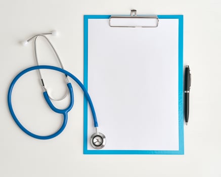 Medicine concept of stethoscope and clibboard, top view closeup photo