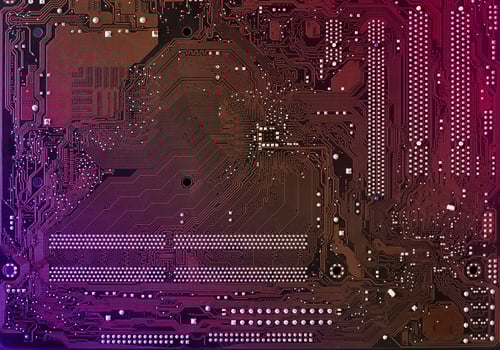 Computer motherboard background with blur neon multicolor glow, pc backdrop, close up photo