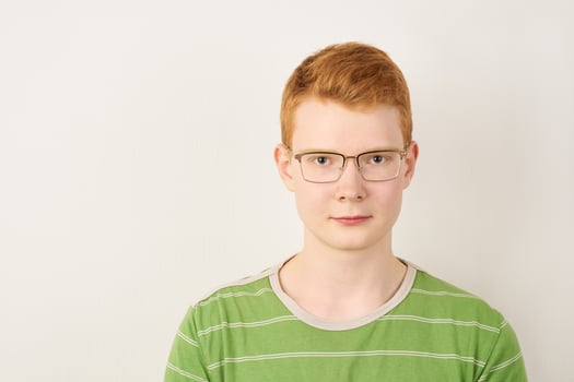 Redhead young man with glasses on white background photo