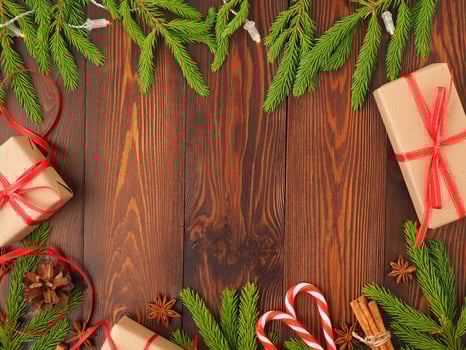 Christmas and Happy New Year dark brown background. Gift Christmas box, fir branches photo