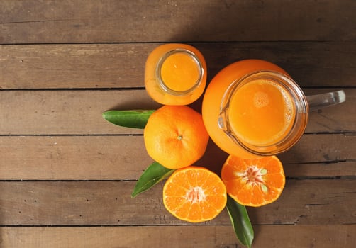 Top view of delicious orange juice on wooden table photo