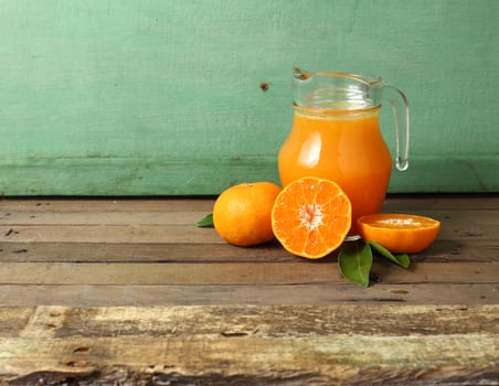 Group of orange and glass of juice on wooden table photo
