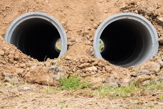 Concrete pipe in dry soil. photo