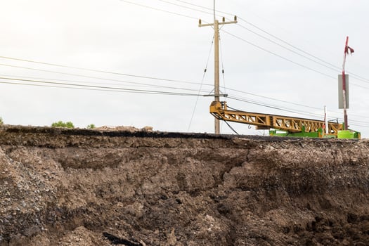 Underground soil under paved road with crane. photo