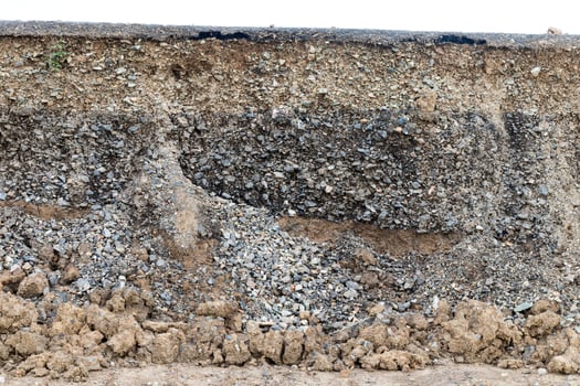 Rocky soil background under paved road. photo