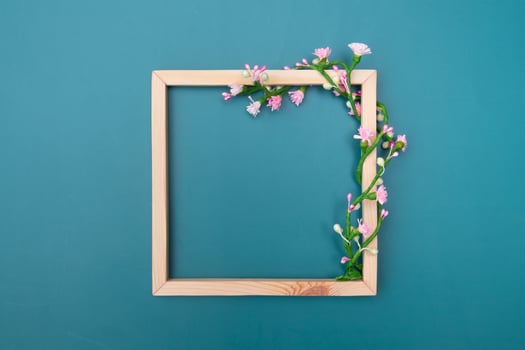 Square wooden frame mock up with decorative floral ornaments with copy space top view photo