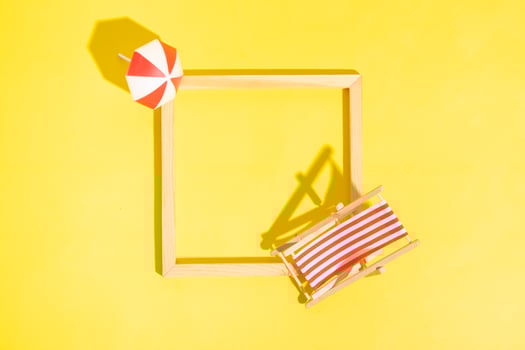 Wooden frame with beach chair and umbrella with copy space top view photo