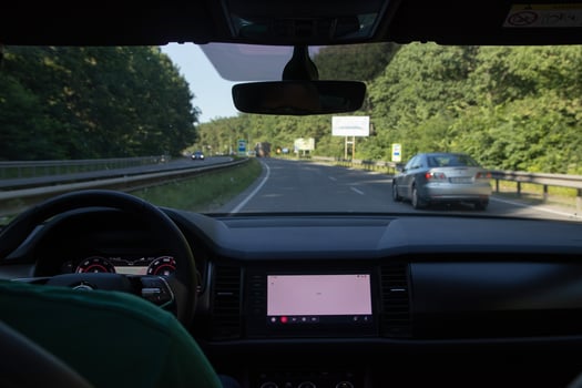 Car interior on the road. Steering wheel, dashboard and on-board display photo