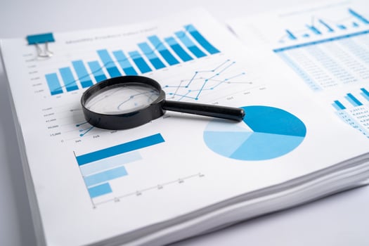 Magnifying glass on charts graphs paper. Financial development, Banking Account, Statistics, Investment Analytic research data economy, Stock exchange trading, Business office company meeting concept. photo