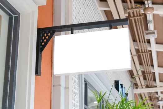 Outdoor business sign mock-up poster display store front, Advertising banners mockup outside a shop photo