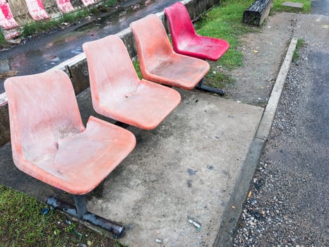 Old plastic chair on the metal row. photo