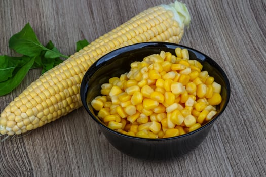 Sweet corn in a bowl on wooden background photo