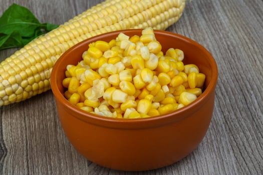 Sweet corn in a bowl on wooden background photo