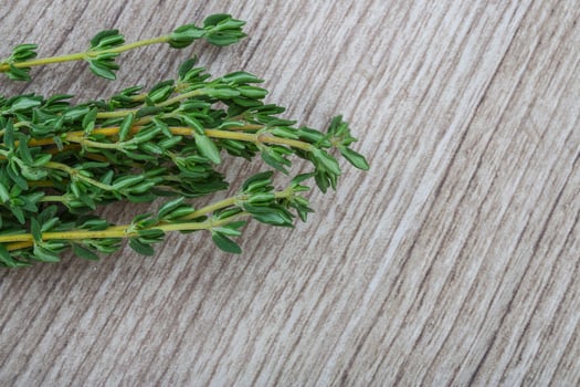 Thyme branch on wooden background photo
