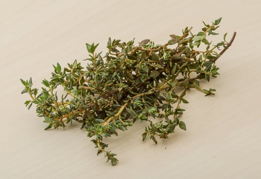 Thyme on wooden background photo
