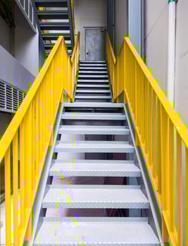 Metal fire escape with the yellow ladder. photo