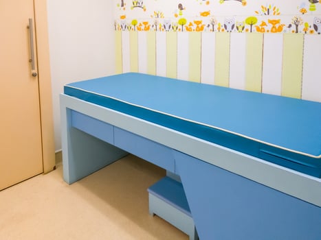 The empty small examination bed in the kid examination room. photo
