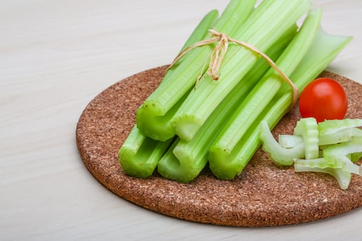 Celery on wooden board and wooden background photo