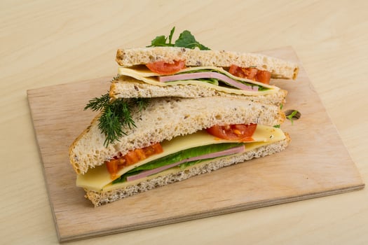 Club sandwich on wooden board and wooden background photo