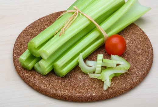 Celery on wooden board and wooden background photo