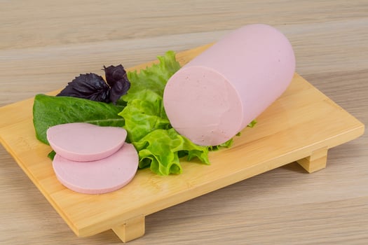 Sausage on wooden board and wooden background photo
