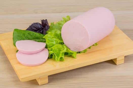 Sausage on wooden board and wooden background photo