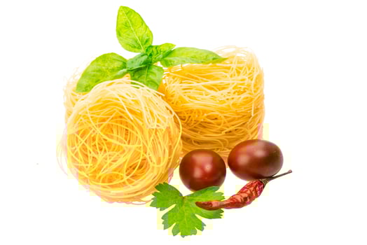 Raw macaroni on white background photo