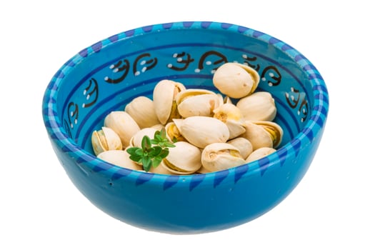 Pistachio in a bowl on white background photo