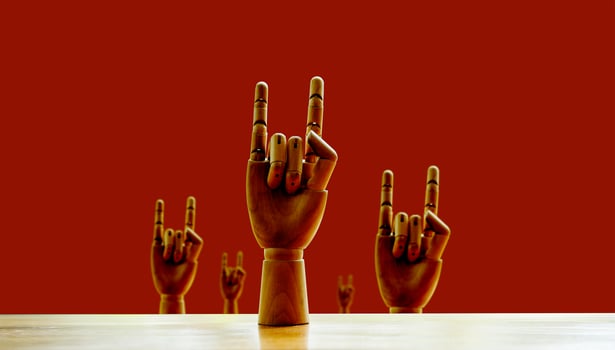 succeed The wooden human hand made a successful gesture and a fighting spirit. Concept of commitment and success photo