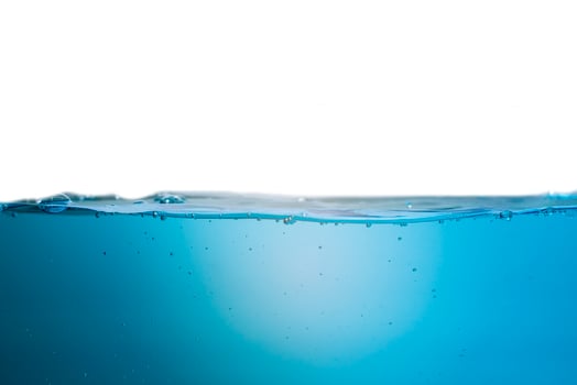 Spectacular ocean waves stop steaming with separate bubbles on a bright sky background. Popular corners, natural concepts photo