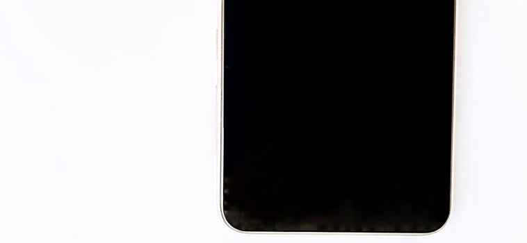 Black screen of smartphone device with a white background. Suitable for company and phone industry promotion, backdrop, poster, tech advertising, etc. photo