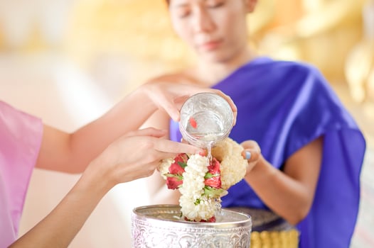 Asian women blessed and gave fresh flower garlands to older women during the Songkran Festival in Thailand photo