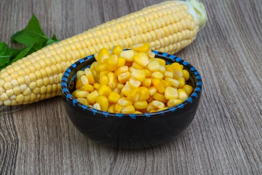 Sweet corn in a bowl on wooden background photo