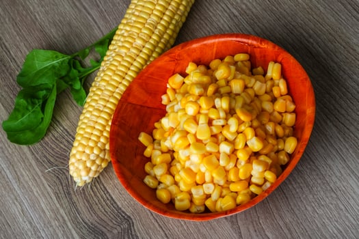 Sweet corn in a bowl on wooden background photo